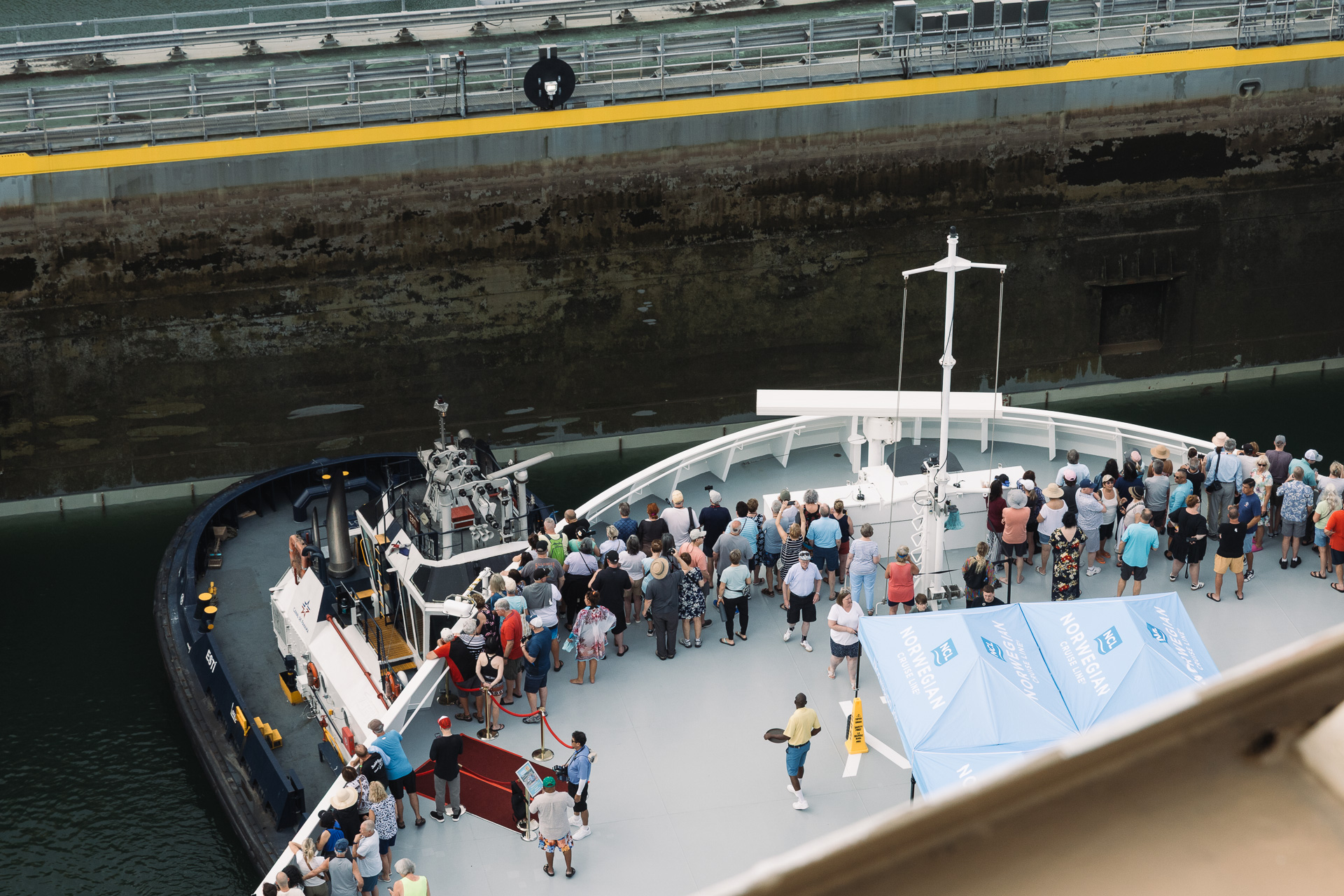 The bow of the NCL Joy cruise ship going through the Agua Clara Locks